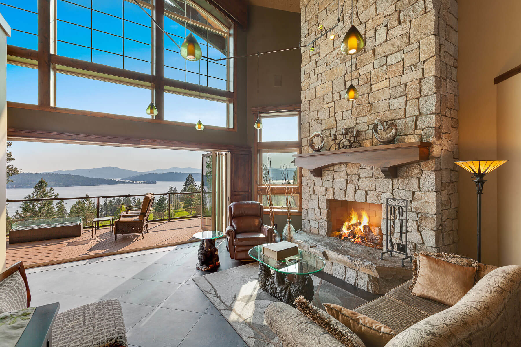 Living room with fireplace and balcony with lake view